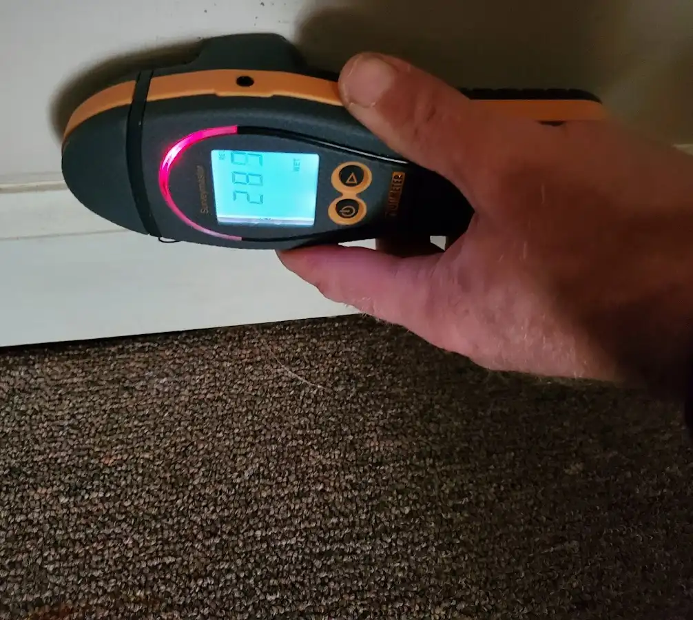 Moisture detection at baseboard during Storm Damage Restoration in Muskegon Heights